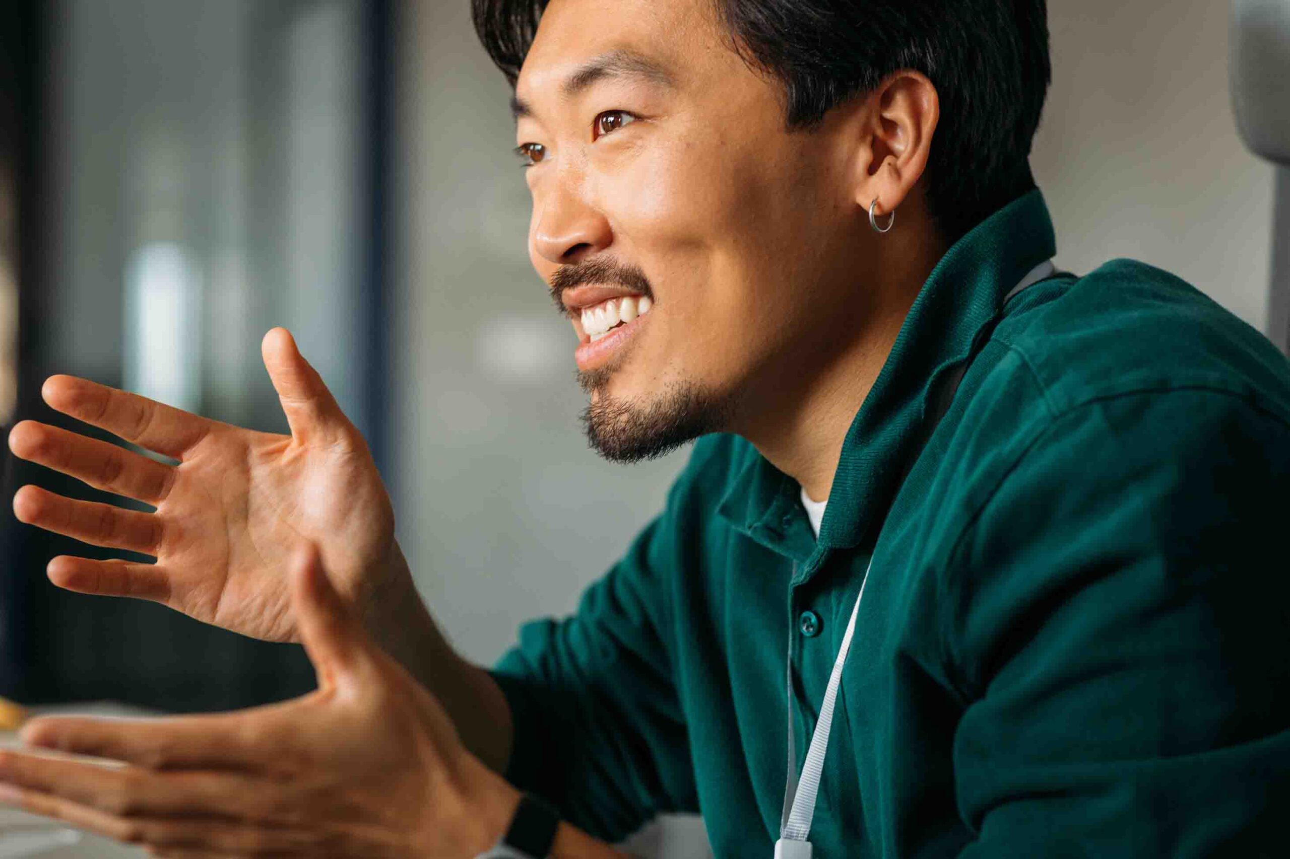 A man smiling and making a hand gesture